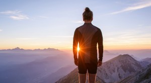 Male hiker observing the sunset at the top of the local big moun